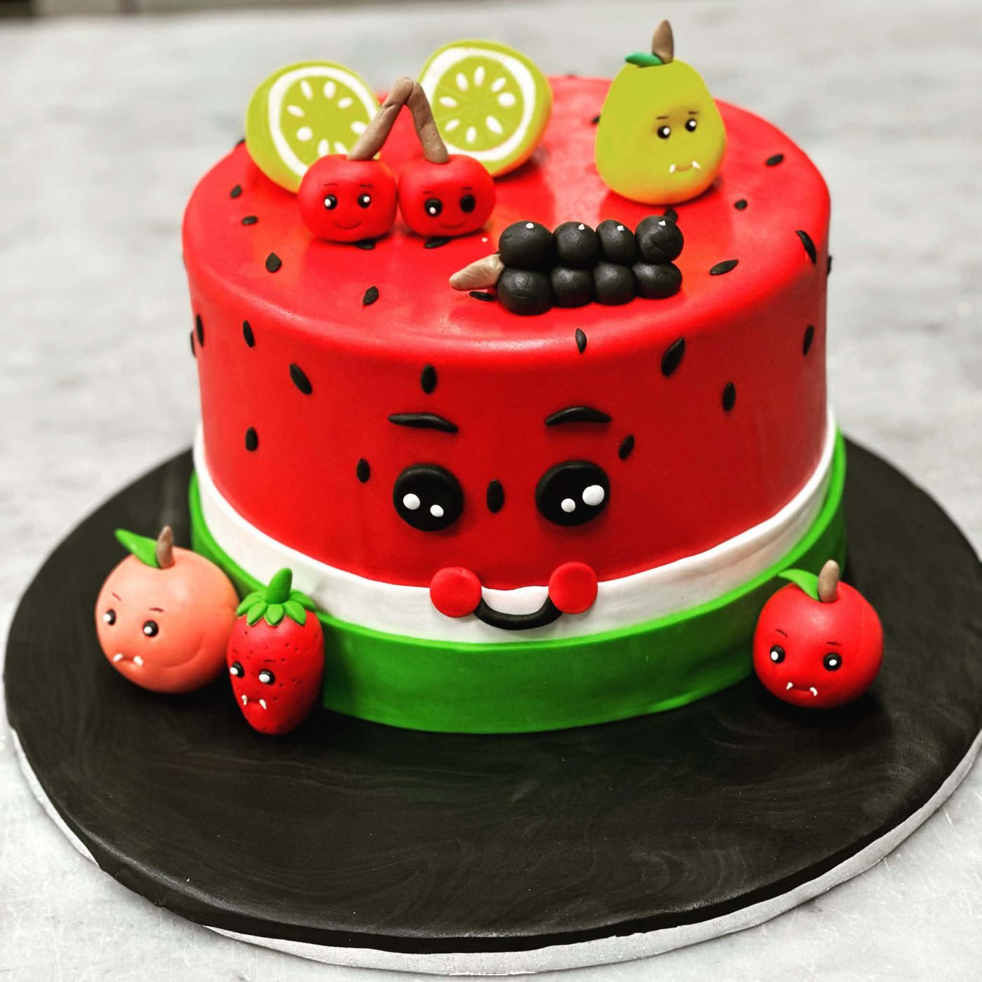 Watermelon cake with smiling sugar fruit characters